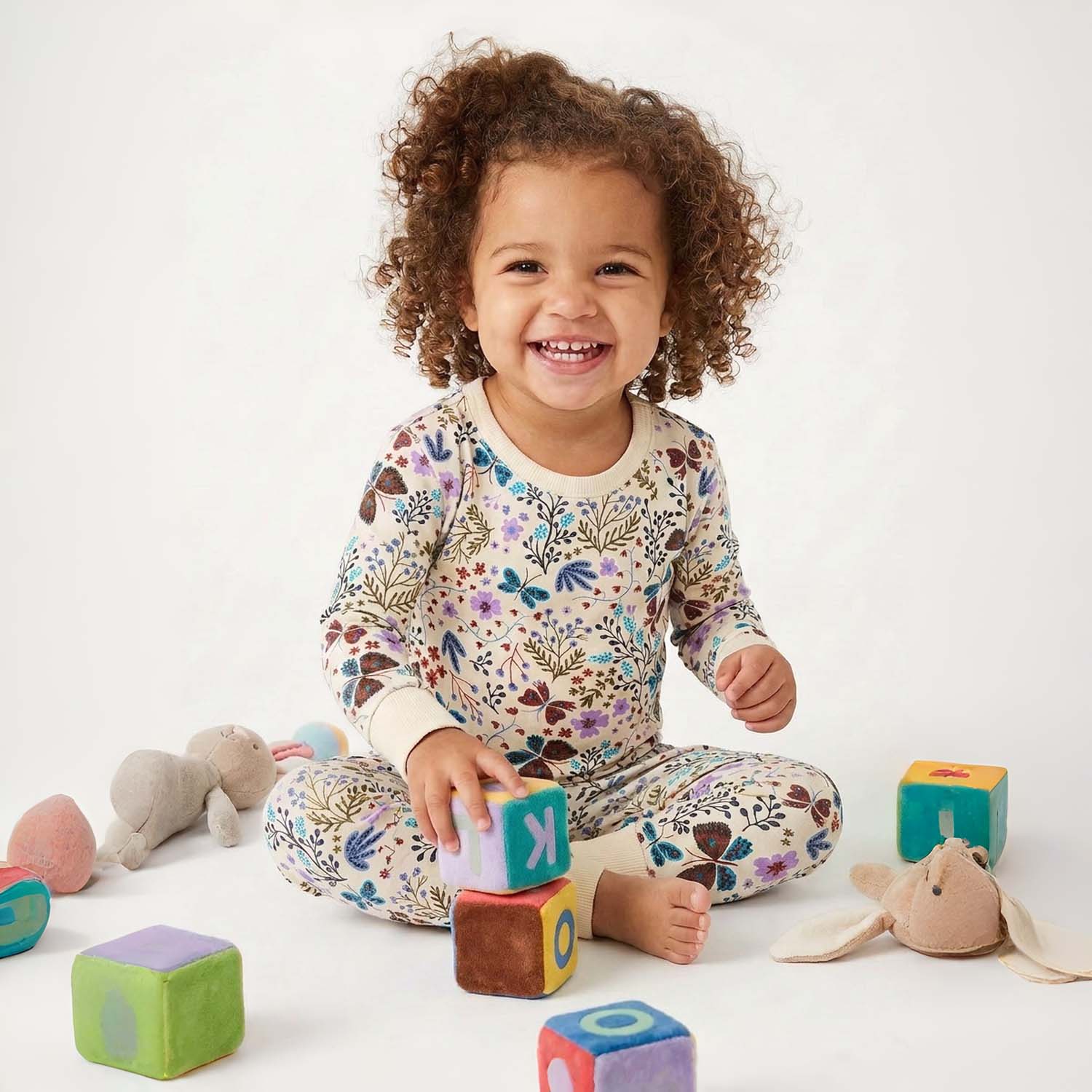 Child playing with colorful blocks on a white background