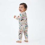 Baby wearing a floral onesie on a white background