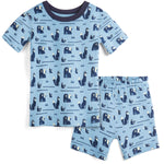 Children's pajama set with bear and fox pattern on a light blue background
