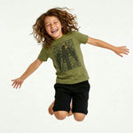 Jumping child wearing a Mightly 100% organic cotton graphic tee with a black crow print and black shorts