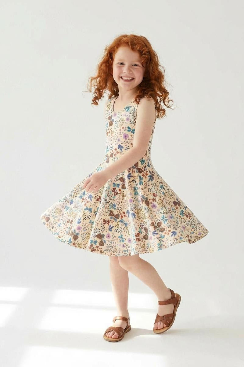 Young girl wearing a floral dress on a white background
