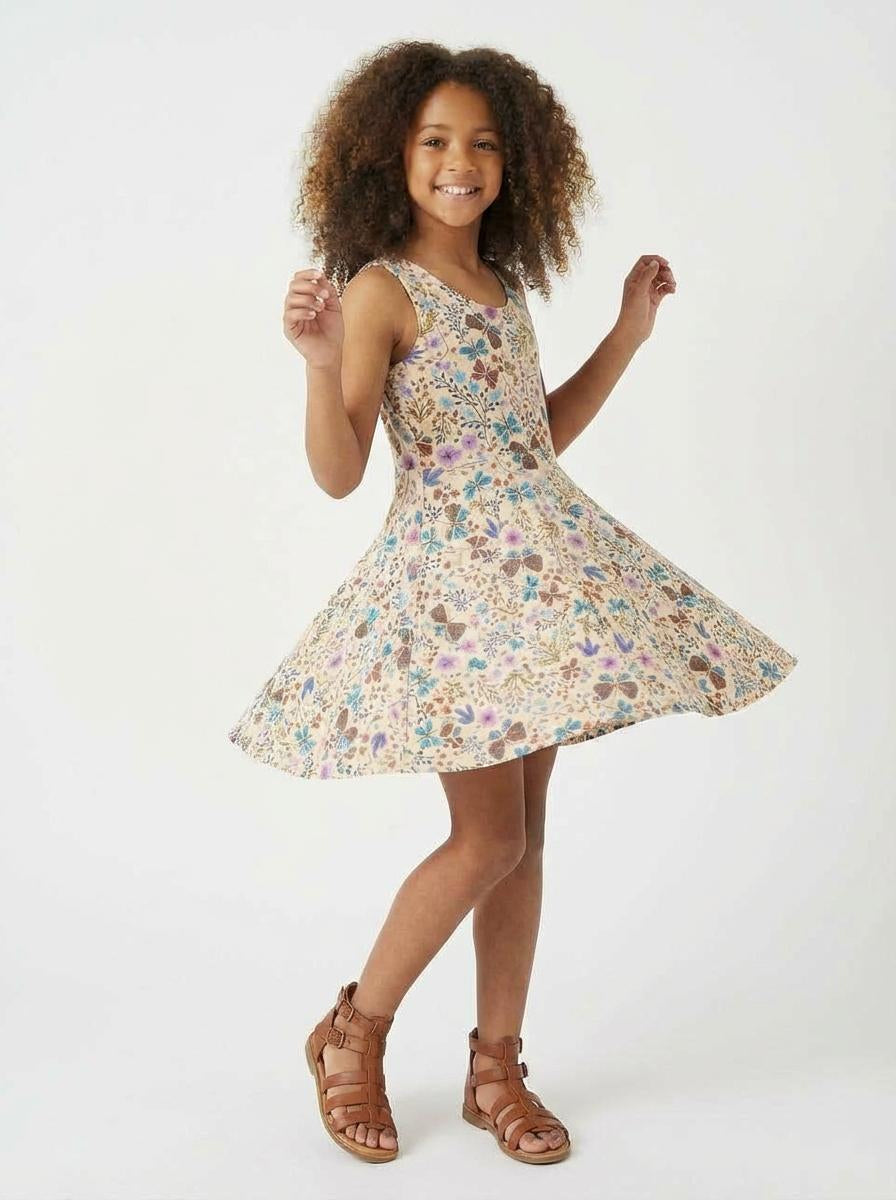 Young girl wearing a floral dress on a white background