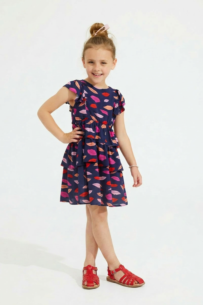 Young girl wearing a colorful dress with a white background