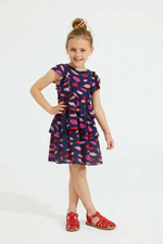 Young girl wearing a colorful dress with a white background