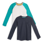 Two long-sleeve kids' shirts, one navy blue with a pocket and one white with teal sleeves, laid flat.